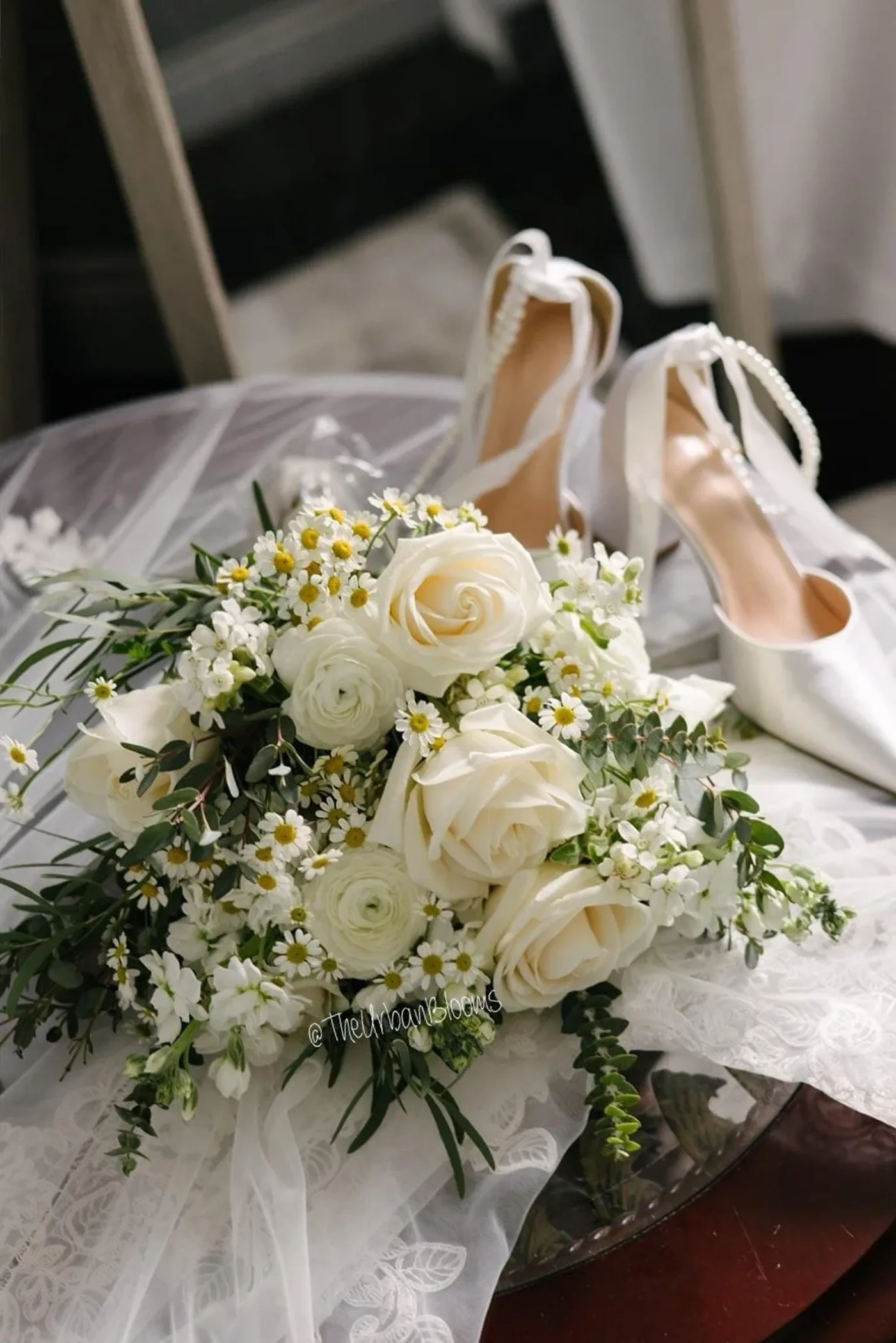 Lush bridal bouquet of white garden roses, ranunculus and chamomile daisies by The Urban Blooms, Toronto wedding florist